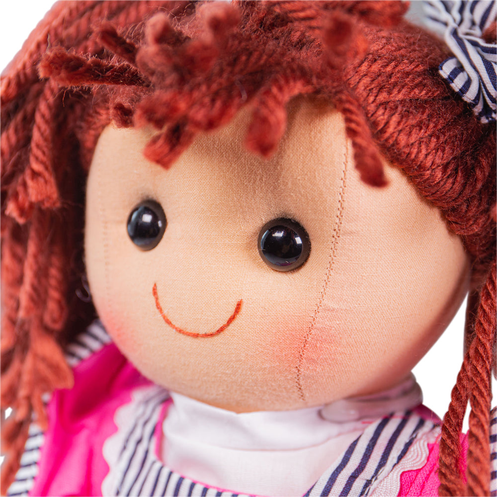 Emma Doll - Large, Emma is ready to meet her new best friend! Emma is soft and cuddly ragdoll, bright as a button and just as loveable. Emma has red hair in bunches and wears a pink dress with striped accents and pink shoes. Emma Doll’s soft material makes her the perfect toddler doll as she’s 38cm tall and gentle on little hands. Emma the ragdoll can easily fit into bags, prams, cots, beds and cars so can be taken anywhere at any time! If your tot has a passion for fashion, Emma's wardrobe can be switched 