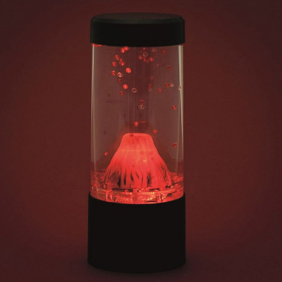 Explosion Volcano Lamp, Embrace the mesmerizing beauty of the Explosion Volcano Lamp and enhance the ambience of any space. Designed for those who appreciate the allure of novelty night lights, this Round Volcano Lamp is a delightful addition to your bedside table, home office desk, or even a child's bedroom.With its cylindrical design, this lamp effectively simulates a volcano, creating a captivating visual display. When turned on, watch as red beads flow out of the top of the volcano, as if it were erupti
