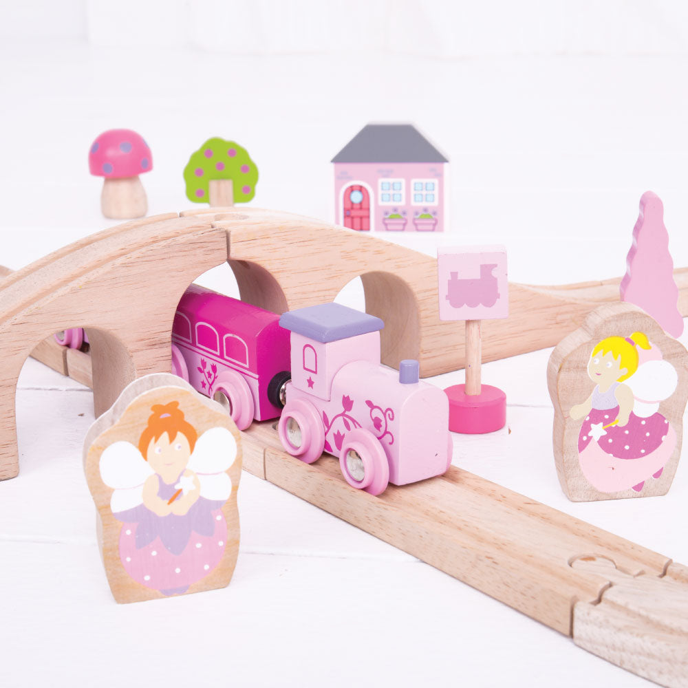 Fairy Figure of Eight, Choo-choo! The Fairy Pink Train Set is ready to depart to a magical fairytale land far, far away. Pinks, pastels and fairy figures feature extensively in this bright and wonderful wooden train set. The Bigjigs Fairy Train Set comes with 35 play pieces to ensure there’s no limit to imaginative play. The cute train engine and colour coordinated carriages pass by pretty houses, trees and toadstools as they travel across the countryside. All aboard for a whimsical adventure! Our Fairy Pin