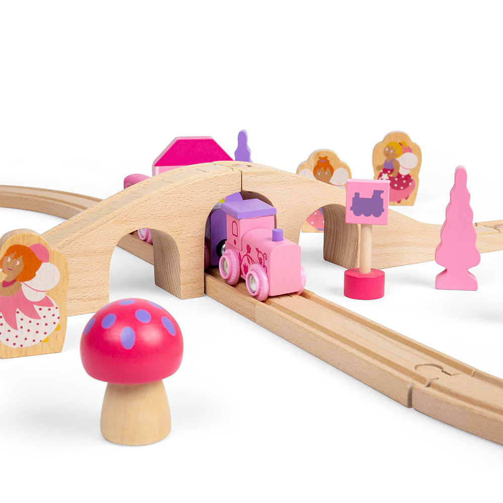 Fairy Figure of Eight, Choo-choo! The Fairy Pink Train Set is ready to depart to a magical fairytale land far, far away. Pinks, pastels and fairy figures feature extensively in this bright and wonderful wooden train set. The Bigjigs Fairy Train Set comes with 35 play pieces to ensure there’s no limit to imaginative play. The cute train engine and colour coordinated carriages pass by pretty houses, trees and toadstools as they travel across the countryside. All aboard for a whimsical adventure! Our Fairy Pin