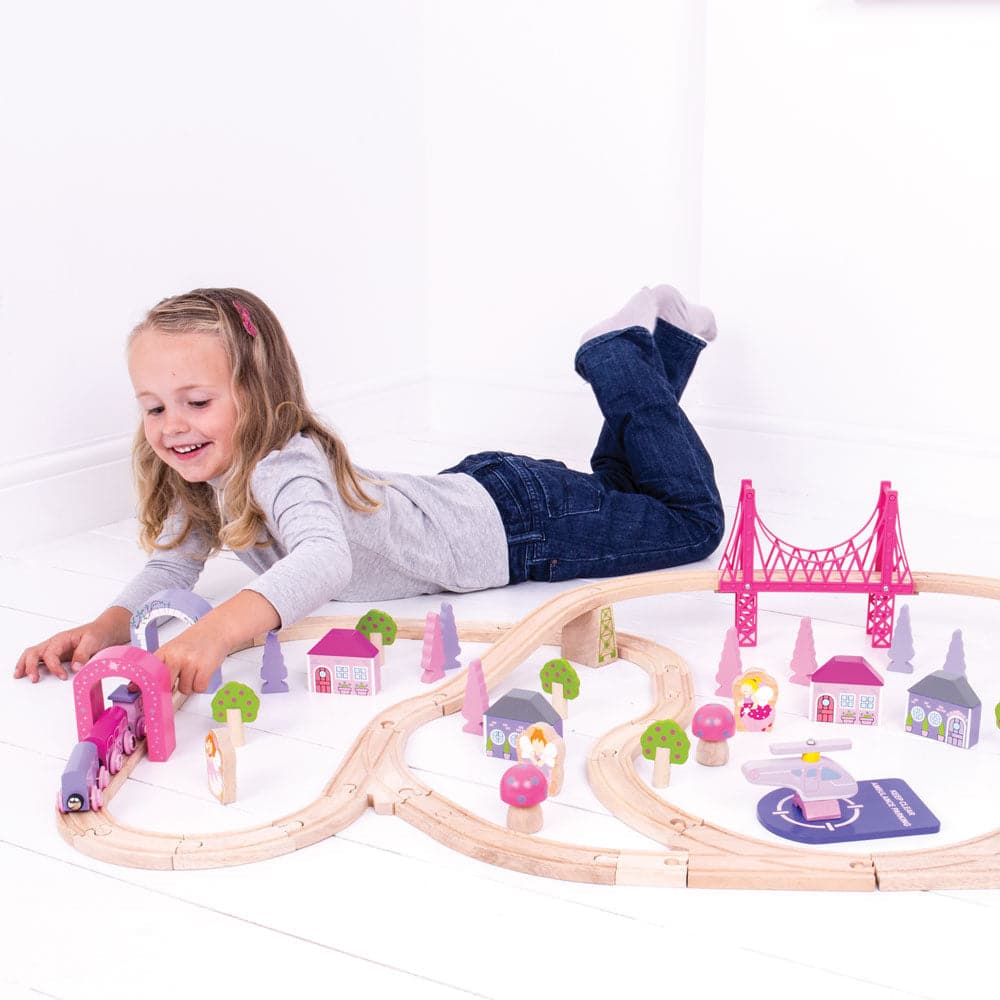 Fairy Town Train Set, A fantastic wooden train set with a sprinkle of fairy dust! The fairies have come to town and the Fairy Town Pink Train Set is ready to depart to a magical fairytale land far, far away. Pinks, pastels and fairy figures all take centre stage with this wonderful wooden train set. This wooden train set comes with 75 play pieces to ensure there’s no limit to imaginative play. From the fairy figures to the brightly coloured trees and houses, even the helicopter is colour coordinated to appe