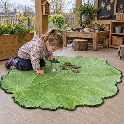 Giant Leaf Playmat in a natural early years outdoor setting with children – image 8 of 8