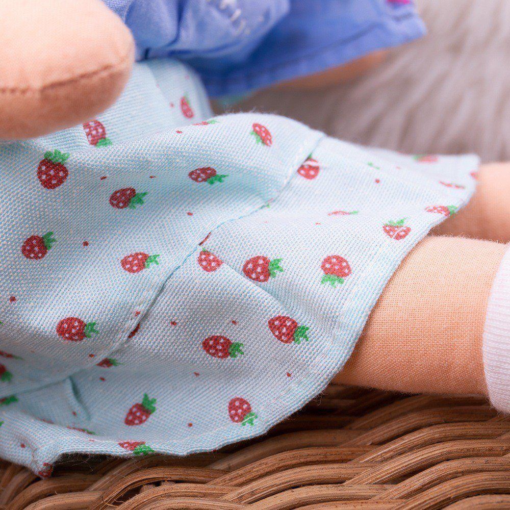 Grace Doll - Small, Introducing Grace, a soft and cuddly rag doll that aims to be your child's new favorite companion. With her sweet blue dress adorned with a delightful strawberry pattern and her hair styled in cute bunches, she's all set to win your little one's heart. Key Features: Soft and Cuddly: Grace is made from soft materials that make her perfect for cuddling. Strawberry Theme: Her beautiful blue dress features a charming strawberry pattern that is sure to delight your child. Cute Hairstyle: Grac