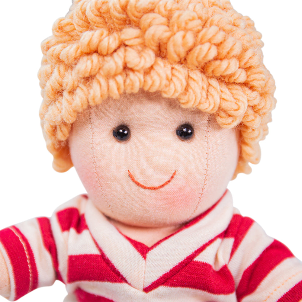Harry Doll - Small, Introducing Harry, the perfect companion for your little one! This soft and cuddly doll is bursting with playful energy and loves nothing more than engaging in endless hours of fun and affectionate snuggles. With his mischievous charm and adorable smile, Harry is sure to capture the hearts of children and adults alike.Harry is always ready for adventure, dressed in his trendy denim shorts and a fashionable stripy top. His outfit not only reflects his playful personality but also makes hi