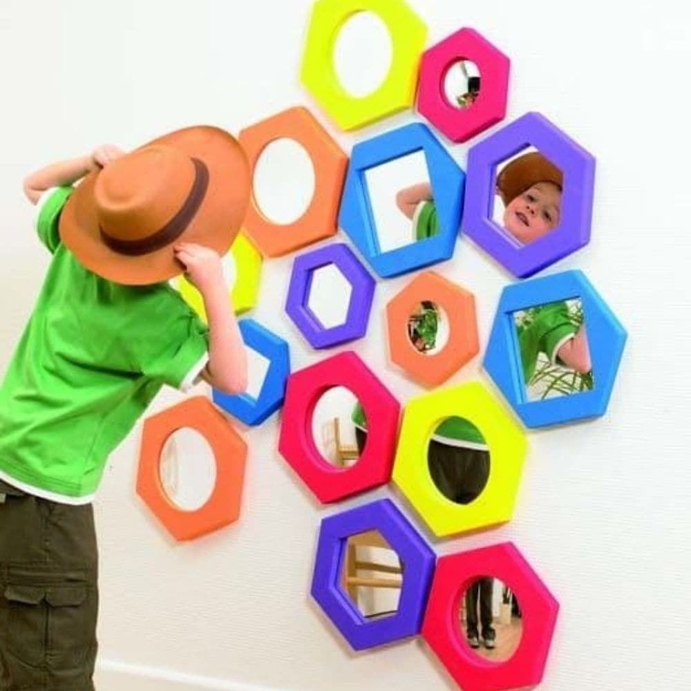 Hexagonal Softie Mirror Set, The Hexagonal Softie Mirror Set can be mounted onto a wall or hand held and used on the go. This Hexagonal Softie Mirror Set is effective in promoting self discovery and recognition. The Hexagonal Softie Mirror Set are made from safe acrylic mirror surrounded in soft foam A fantastic set of 5 hand-held, foam surround mirrors in plane (purple, blue and yellow), convex (red) and concave (orange). Like all Softies they have tough waterproof EVA foam frames surrounding safe acrylic 