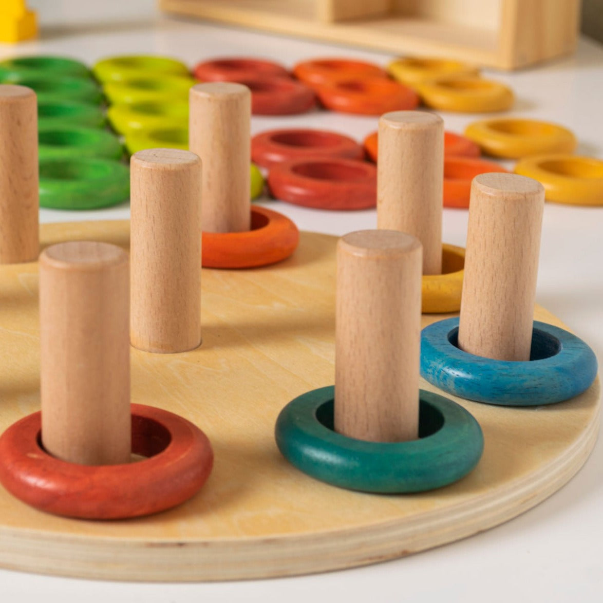 Hooping Rings, Introducing our Hooping Rings 9-piece wooden ring set, designed to inspire creativity and learning in young children! The Hooping Rings set is made from sustainably sourced beech wood, rubber wood, and plywood, this set is both durable and eco-friendly.Featuring 5 rings in each bright and engaging colour, children can use their imaginations to stack the rings in order, create patterns, or even come up with their own designs. The possibilities are endless with this open-ended set!Not only is t