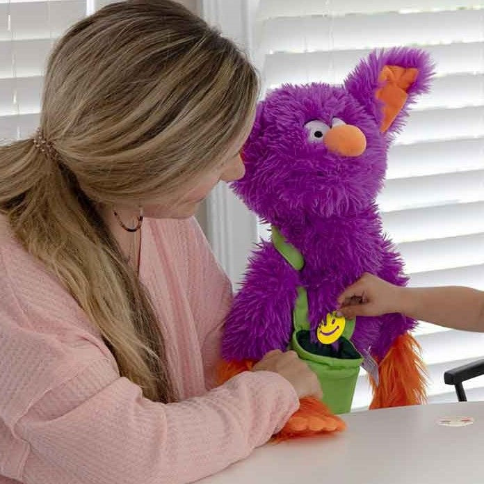 Interactive Edgar The Emotions Puppet, Meet Interactive Edgar The Emotions Puppet! With his bright colours, super-soft fur and silly face, he's been created to help children to share their emotions. Research indicates that it's easier for children to open up to a puppet than to a teacher or adult (even though that's who is operating the puppet). Edgar comes with a bright green pouch with 12 colourful emotion faces, and children can use these as the basis for discussion, and as a route to understanding and s