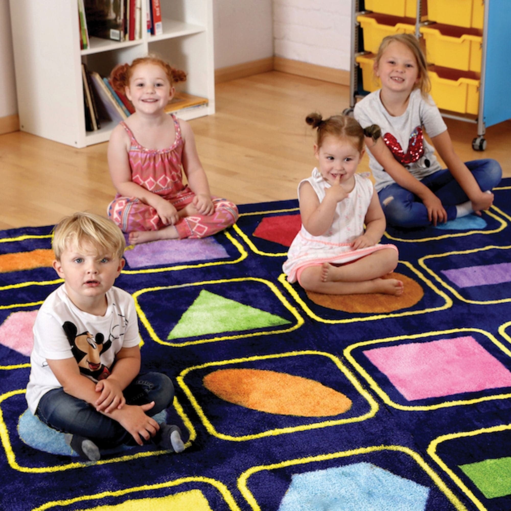 Kindercolour Geometric Shapes Carpet 3 X 3 Metre, The Kindercolour™Geometric Shapes Carpet is a huge 3m square placement carpet with clearly recognisable seating areas for up to 30 children. These brightly coloured basic shapes aid shape and pattern identification. Heavy duty Dura-Pile™, substantial premium quality carpet, with an extra thick pile. Soft textured, tufted Nylon twist pile, designed specifically for comfort and longevity. Ideal for early years and primary school learning environments. Tightly 