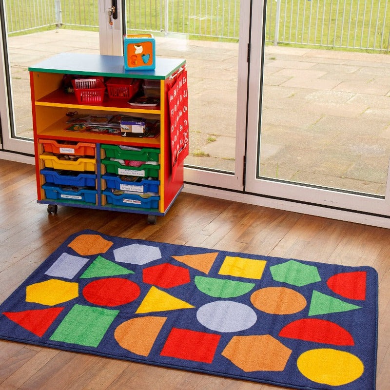 Kinder™ Primary Geometric Nursery Rug, Introducing the Kinder™ Primary Geometric Nursery Rug, a perfect tool for aiding young children in their exploration of shapes and spaces. This rug is thoughtfully designed to enhance early years and primary school learning environments.Crafted from our Heavy Duty Dura-Pile™, this premium-quality carpet boasts an extra thick pile, ensuring both comfort and longevity. The soft, textured tufted Nylon twist pile provides a plush surface for children to engage with as they