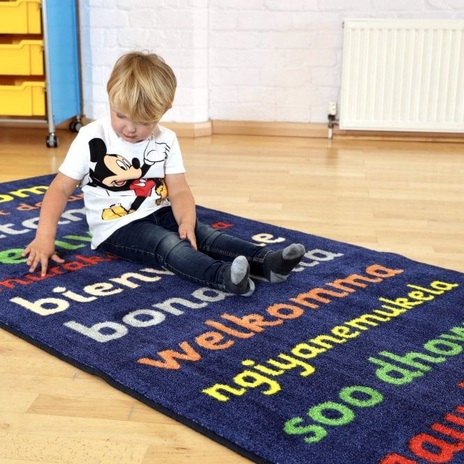 Kinder™Welcome Runner Carpet 3 X 1 Metre, The Kinder™Welcome Runner Carpet is the perfect addition to any Early Years Foundation Stage (EYFS) setting. Measuring 3 x 1 metre, it is not only visually appealing but also highly functional.Featuring the word "Welcome" in a variety of different languages, this carpet promotes inclusivity and diversity in your learning environment. Children will feel welcomed and valued as they explore and play on this vibrant and educational carpet.Constructed with a substantial 