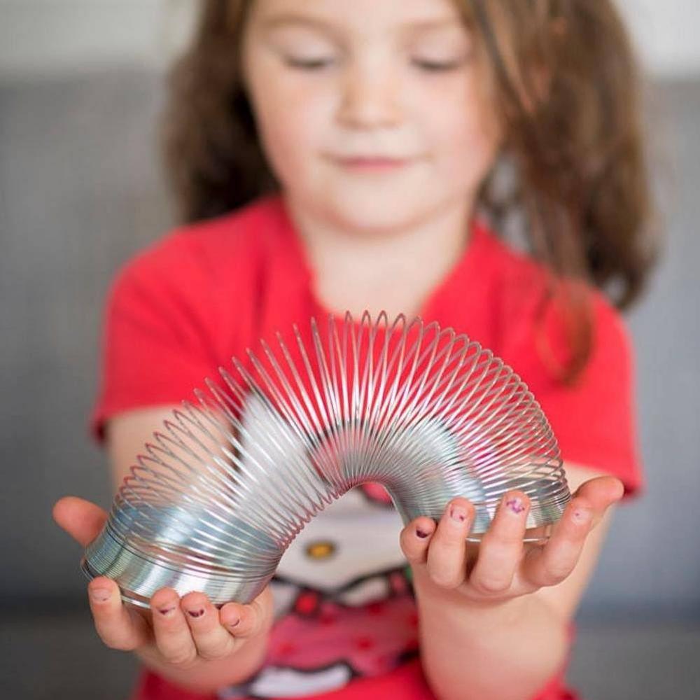 Large Metal Spring, Rediscover the magic and joy of the iconic Slinky with our Large Metal Spring! Crafted meticulously from lustrous metal, this toy is not just a sight to behold but also a delight to play with. Key Features: Metal Mastery: Made from polished metal, our Large Metal Spring gleams with every twist and turn, making it a visually captivating toy. Versatile Play: Whether you’re stretching it, bouncing it between your hands, or letting it "walk" down the stairs, there's no end to the fun you can