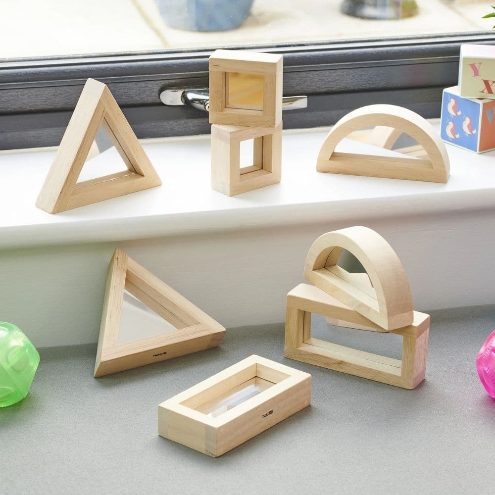 Large Mirror Block Set, Discover a world of shapes, reflections, and tactile exploration with the TickiT® Large Mirror Blocks set. The Large Mirror Block Set are crafted from high-quality rubberwood and featuring double-sided acrylic mirror centres, this set offers a multi-sensory experience that goes beyond traditional block building. Suitable for children as young as 12 months, these mirror blocks are designed to stimulate young minds and ignite their imaginations. What's Included in the Large Mirror Bloc