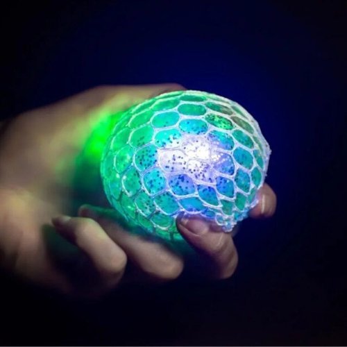 Light up Gripper Stress Ball, Experience a whole new level of stress relief with the mesmerizing Light-Up Gripper Stress Ball! With its unique design and captivating light show, this stress ball promises endless hours of squeezing, squishing, and fidgeting fun. Light up Gripper Stress Ball Features: Transformative Texture: Enclosed within a mesh net, every squeeze causes the stress ball to mutate, producing hundreds of grape-like nodules that protrude through the mesh, offering a tactile sensation like no o