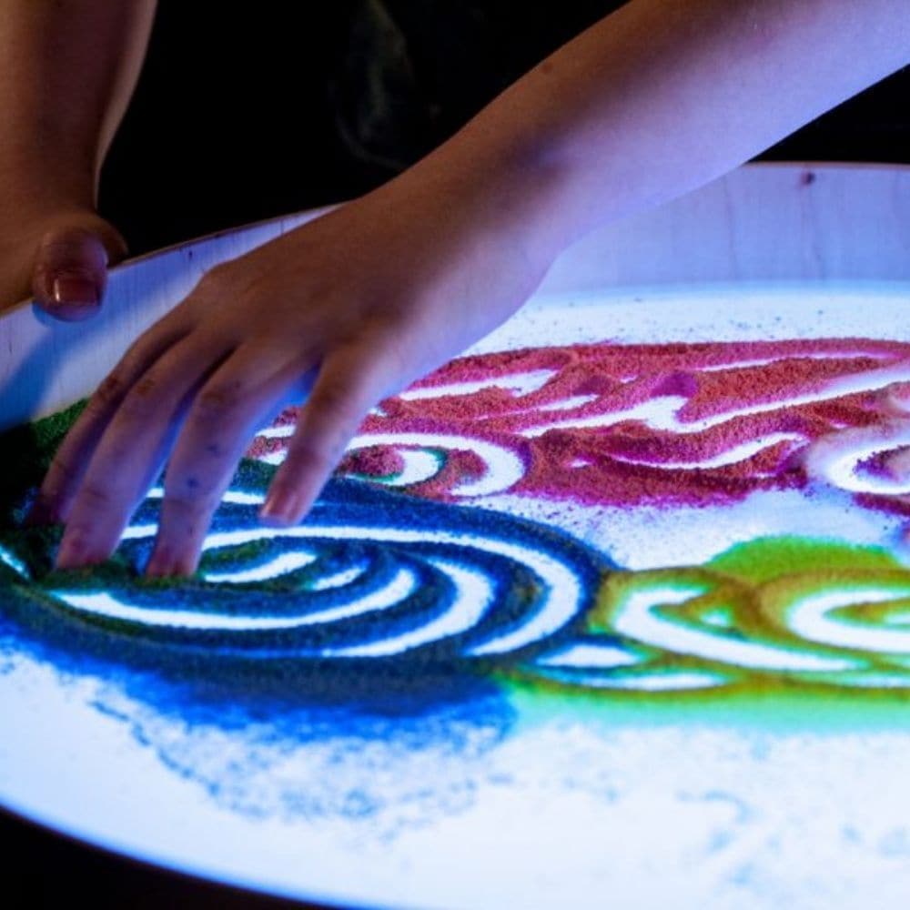 Magic Light Table, Magic light table is a small and lightweight table designed for games, art and therapy. The table has a higher edge preventing sand, semolina and other small elements used for creation from spilling. The light consisting of even 16 different colours and four different automatic colour change programs help create an impression of playfulness of the table. You can draw with your fingers, brushes and pads on the table. A special sand raker, air blown through the straw, foot or palm imprints 