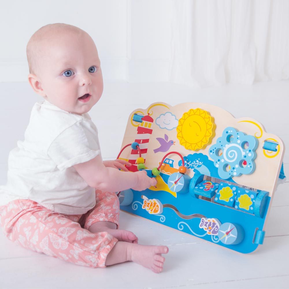 Marine Activity Centre, Encourage your toddler’s dexterity and matching skills with the help of this wooden Marine Activity Centre! This baby activity toy comes complete with straps to attach the Activity Centre to a cot bed so little ones can entertain themselves when they wake up. This unique wooden baby toy features a spinning sun and flower as well as three matching shell and seahorse blocks. Little hands can also help the birds move up and down the beaded wire and guide the fish. Made from high quality