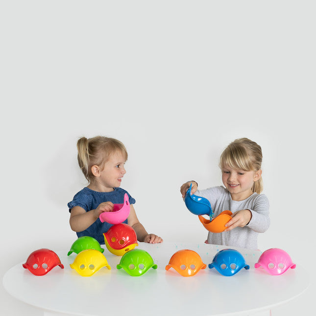 Moluk Bilibo Mini Set, Introducing Mini Bilibo's by Moluk, the latest addition to the award-winning Bilibo line of toys. These mini versions carry the same iconic shape and vibrant colour palette that has made Bilibo a favourite among kids worldwide. Designed to stimulate creative, sensory play, Mini Bilibo's are perfect for little hands to hold, stack, and explore. While the original Bilibo's multifunctional design allowed for rocking, spinning, hiding, sitting, and peeking, these mini versions bring a new