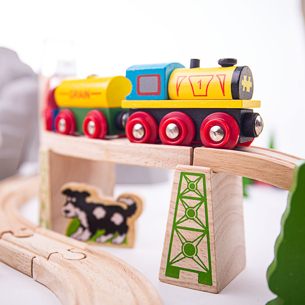 Mountain Railway Set, Mini mountaineers are going to love playing with our Mountain Wooden Train Set. This wooden railway set towers above other train sets and comes packed with a range of activities to broaden and educate young minds. In this kids wooden train set is a working crane, a classically styled railway station plus a turntable, bridges and viaducts among the many train set components. Wooden cars, commercial vehicles, workmen and village folk all help to populate the busy landscape. Consists of 1