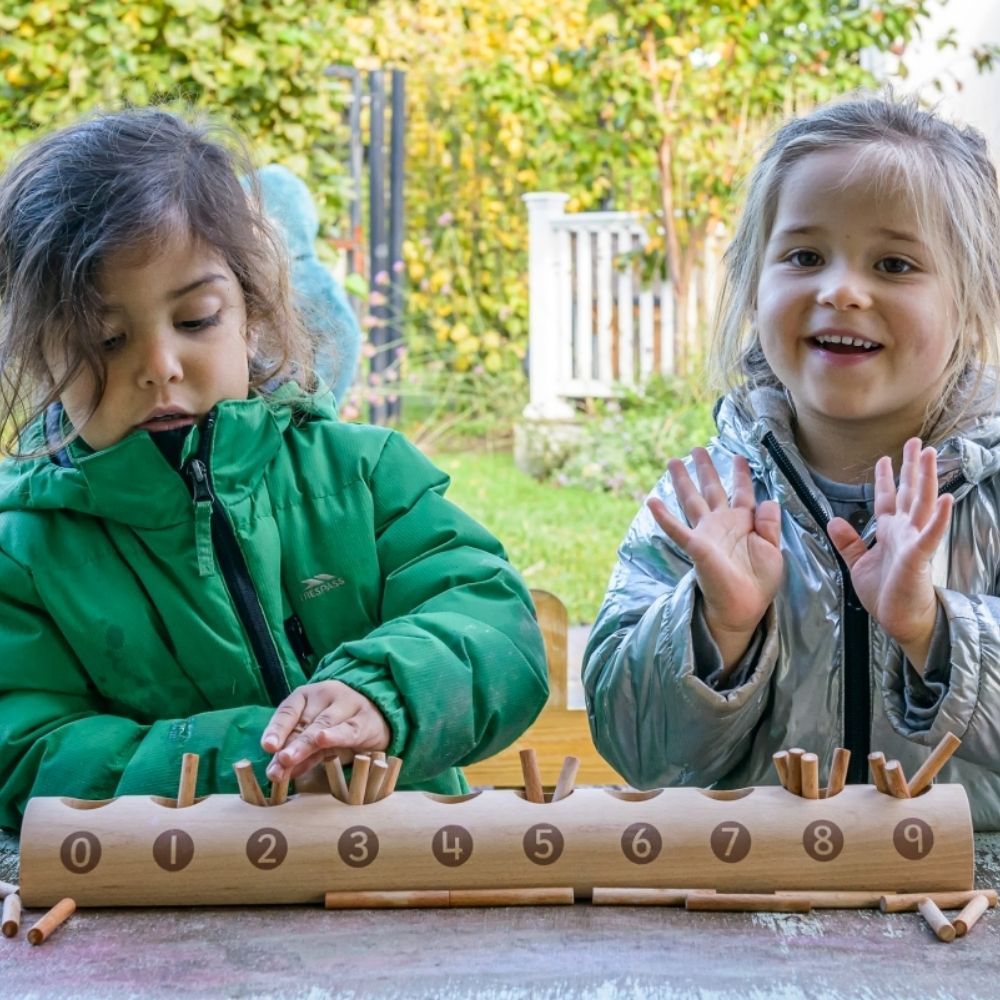 Natural Counting Log, This simple Natural Counting Log has equal-sized holes into which children can count out the appropriate number of sticks from a pile. When placed correctly in the sections, children can easily see the difference between the numbers (cardinality). Each side of the Natural Counting Log shows a slightly different range of numerals (1–10 on one side and 0–9 on the other), making it helpful to teach number order and the value of zero. The Natural Counting Log is made from FSC beech wood th
