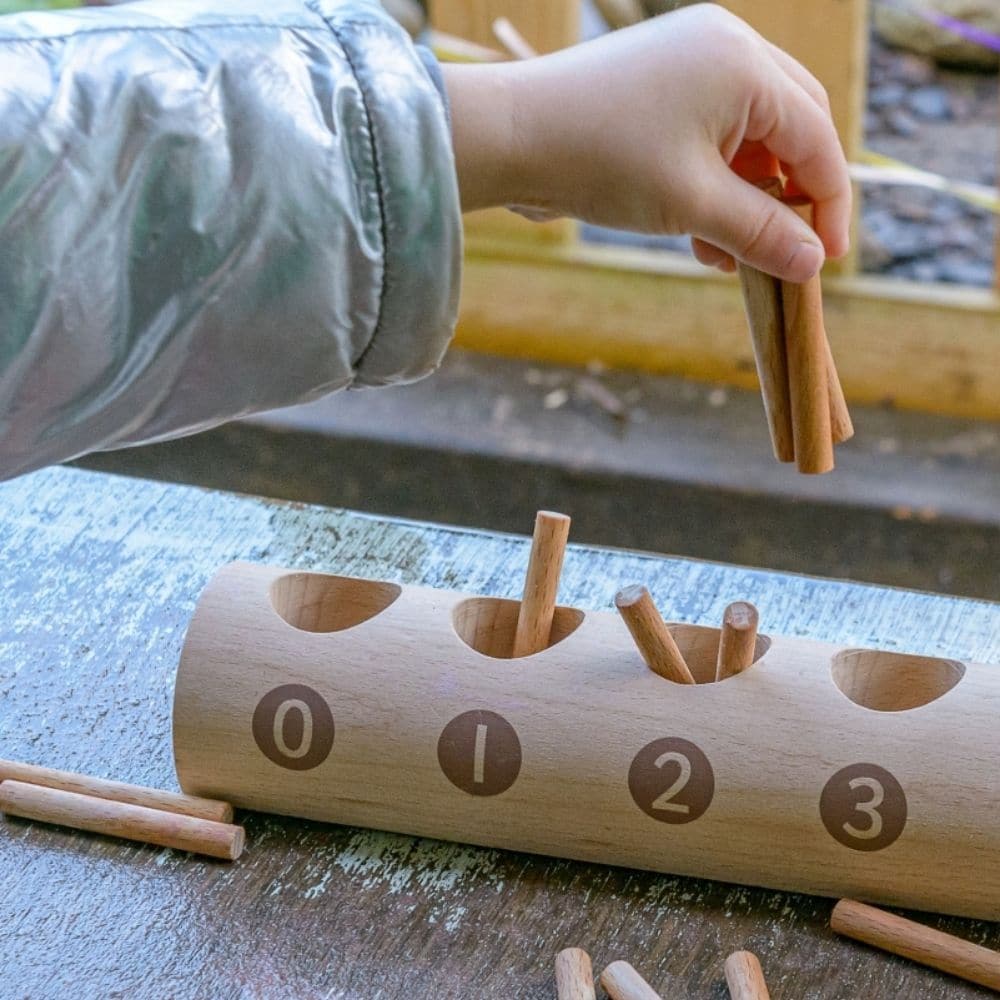 Natural Counting Log, This simple Natural Counting Log has equal-sized holes into which children can count out the appropriate number of sticks from a pile. When placed correctly in the sections, children can easily see the difference between the numbers (cardinality). Each side of the Natural Counting Log shows a slightly different range of numerals (1–10 on one side and 0–9 on the other), making it helpful to teach number order and the value of zero. The Natural Counting Log is made from FSC beech wood th