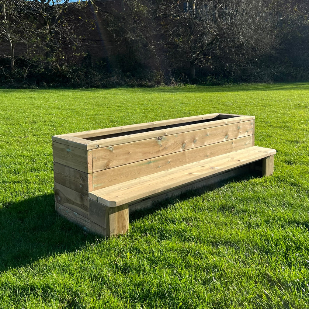 Outdoor Bench Planter, A simple, rectangular designed planter with bench seating to one side. Children can get stuck into potting and planting their very own fruit and veg with friends, building on their social communication skills whilst doing so! A fantastic resource for any educational setting; this will encourage children to appreciate nature and their surroundings. Made from sustainable FSC Pressure Treated Redwood Timber. Please Note: This item is kerbside delivery only. Reasons to Love A fantastic re