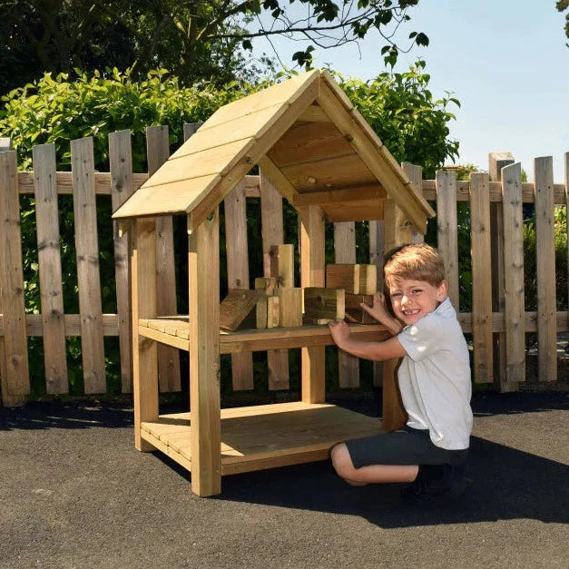 Outdoor Building Blocks House, The Outdoor Building Blocks House is a fantastic resource that allows children to engage in both maths and construction play. This well-designed and manufactured product is a great addition to any early years playground. With its storage shelf, children can not only have fun building and creating but also develop vital social interaction skills and fine motor skills. This Outdoor Building Blocks House provides an enriching and enjoyable learning experience for children of all 