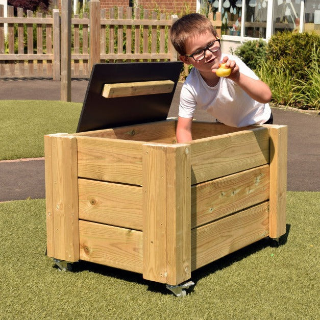 Outdoor Wheelie Storage Box, Introducing our Outdoor Wheelie Storage Box, the perfect solution for making storage fun in outdoor play spaces. This multi-functional resource allows children to easily wheel it around the playground while also providing opportunities to practice their mark-making skills on the lid and plaque when the unit is stationary.The chalkboard lid features two handles, making it effortless for children to lift and engage with. It is designed to be lightweight, ensuring that kids can con