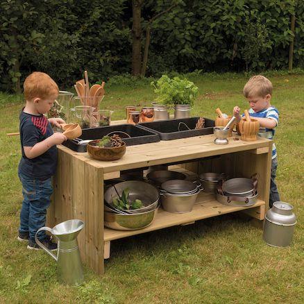 Outdoor Wooden Group Discovery Table, The Outdoor Wooden Group Discovery Table is a large outdoor wooden table with a storage shelf and plastic basins. The Outdoor Wooden Group Discovery Table has enough space for lots of children and table space to experiment. Children can transfer materials from one bowl to the other. Why not have a liquid in one tub, and a solid in another? The Outdoor Wooden Group Discovery Table allows children to experiment with multiple textures and forms. The basins remove for exten