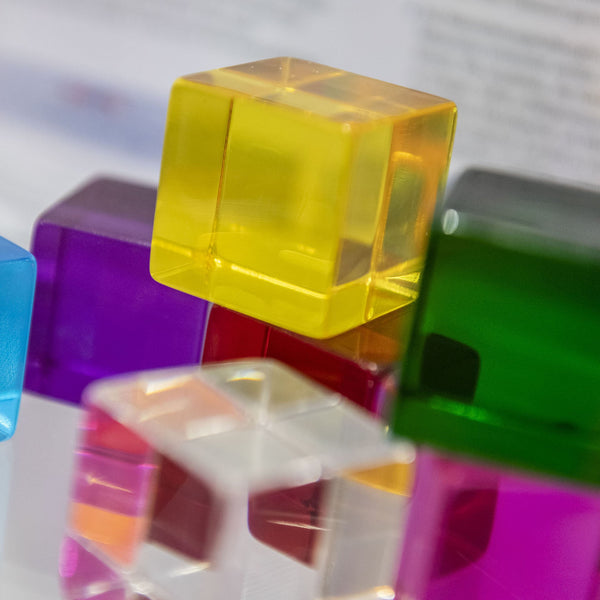 Perception Cubes, The sensory Perception Cubes come in eight different clear colours and feel smooth and inviting to touch. The very youngest children will enjoy handling the Perception Cubes in free sensory play or as part of a treasure basket collection. Older children will find the Perception Cubes fascinating as they hold them up and look through to see the world around them in different colours. Holding two or three Perception Cubes together creates new colours and hues; using the cubes on a light pane