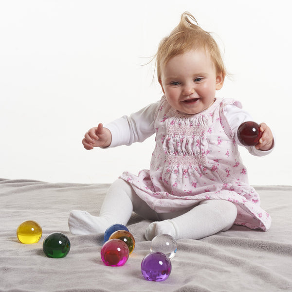 Perception Spheres Pack of 8, The Perception Spheres come in eight different clear colours and are soft and warm to the touch. The very youngest children will enjoy handling the Perception Spheres in free sensory play or a part of a Treasure Basket collection. Older children will find the Perception Spheres fascinating as they hold them up and look through them seeing the world around them in different colours. The way light behaves when children look through the Perception Spheres they will also see the wo