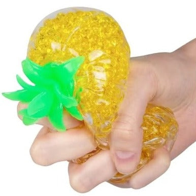 Pineapple Squishy Stress Ball, Soft toy shaped like a pineapple and filled with hundreds of jelly-like balls. It's a squishy toy that's quite unlike anything else in our collection, as the jelly balls inside provide an interesting tactile experience when squeezed. The Pineapple Squishy Stress Ball can be squished and squeezed over and over, but always snaps back to its original shape as soon as you put it down. Pineapple Squishy Stress Ball Soft toy shaped like a pineapple Filled with hundreds of jelly-like