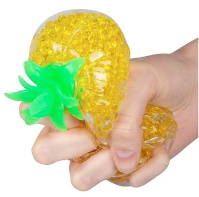 Pineapple Squishy Stress Ball, Soft toy shaped like a pineapple and filled with hundreds of jelly-like balls. It's a squishy toy that's quite unlike anything else in our collection, as the jelly balls inside provide an interesting tactile experience when squeezed. The Pineapple Squishy Stress Ball can be squished and squeezed over and over, but always snaps back to its original shape as soon as you put it down. Pineapple Squishy Stress Ball Soft toy shaped like a pineapple Filled with hundreds of jelly-like
