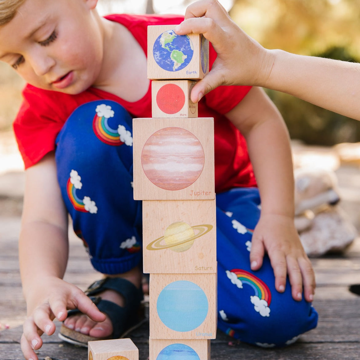 Playing with Planets, Take learning to a new level with this set of beautifully illustrated blocks that will take your little one on a journey through outer space. With eight blocks, one for each planet in our solar system, children can explore the size and distance of each planet from the Earth. The diameter of each planet is displayed on the blocks, aiding in the understanding of size ratios and distance in space. Stacking the blocks is not only fun, but also helps develop their fine motor and cognitive s