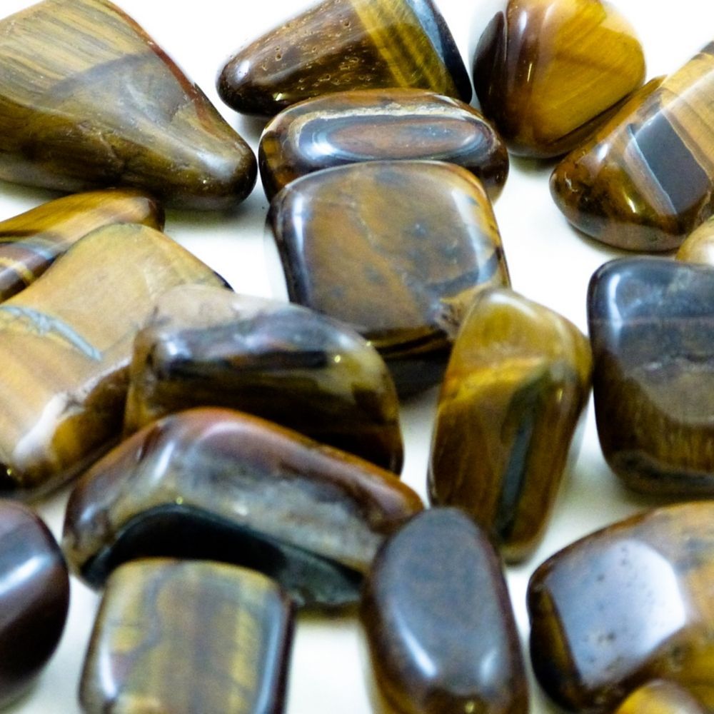 Polished Stones Tiger Eye 1kg, These Polished Stones Tiger Eye are a unique and captivating addition to your sensory resources. Allow children to run their fingers over each smooth surface or roll them around in the light to appreciate the unique print. Each of these Polished Stones Tiger Eye can be used for exploration play or paired with adhesives to create art pieces such as natural mosaics. The Polished Stones Tiger Eye each have an organic striped colour which, in itself draws you in, and come in a lar