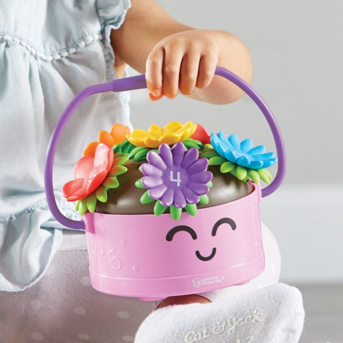Poppy The Count & Stack Flower Pot, Meet Poppy and her 6 colourful count-and-stack-flowers! They're ready for preschool fine motor fun. Stack Poppy’s 2-piece flowers, then count them up with this flower pot toy. As they pick Poppy’s flowers or carry her around with her child-sized handle, toddlers and preschoolers build new skills during imaginative play adventures. Learning fun is always in bloom with Poppy and her colourful flowers. Poppy The Count & Stack Flower Pot Whether they're learning in preschool 