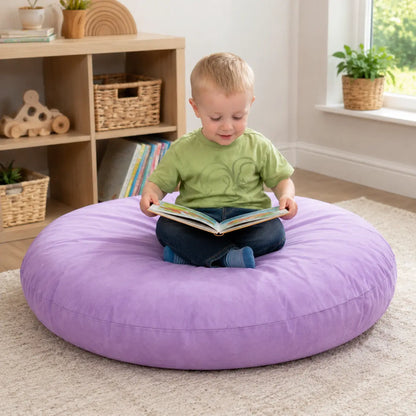 Purple Large Round Floor Cushion reading in a naturally lit early years nursery