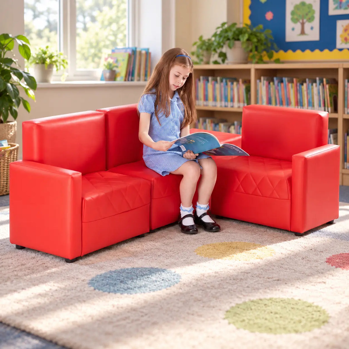 Red PVC Reading Corner Sofas with child reading in a school library