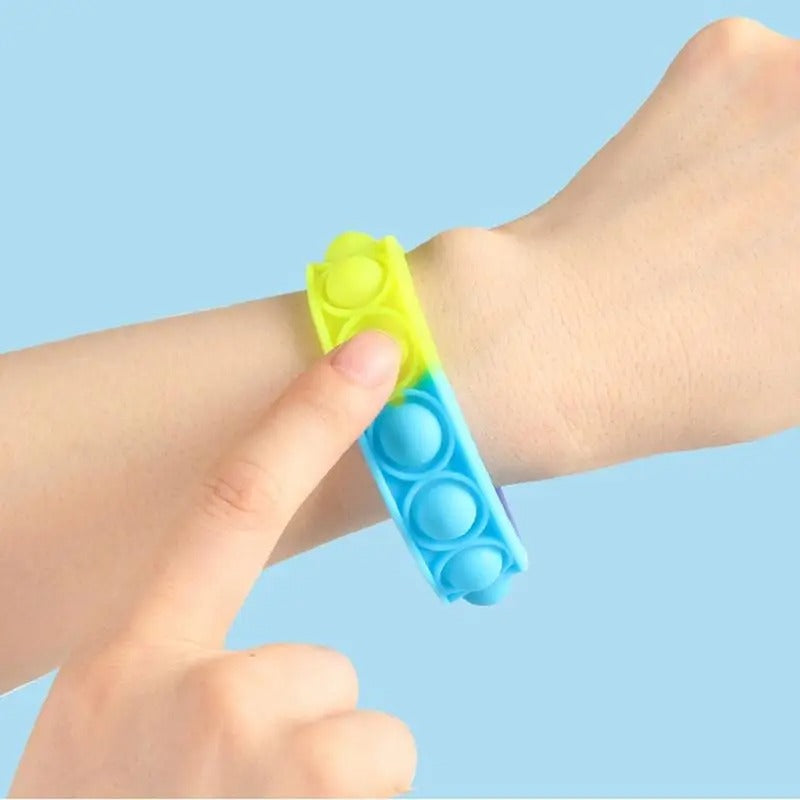 Rainbow Fidget Wristband, Introducing the Rainbow Fidget Wristband, the ultimate sensory tool that will keep you entertained and relaxed for hours on end. If you've ever found joy in popping bubble wrap, then this is the perfect gadget for you. This wristband is designed to divert a busy mind, providing a therapeutic experience that helps relieve stress and anxiety. Made from high-quality silicone, it features a series of mouse-shaped bubbles that can be easily pressed down to emit a satisfying popping soun