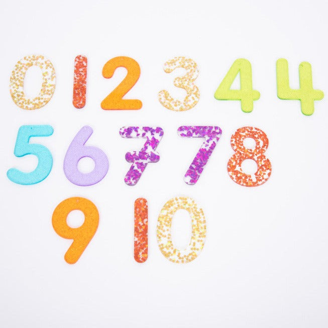 Rainbow Glitter Numbers - Pk14, The Rainbow Glitter Numbers are a set of 14 sparkling glitter numbers 0-9 made from colourful translucent 3mm acrylic. The Rainbow Glitter Numbers set includes two styles of the numbers 4 and 7, with an additional 1 & 0. They are ideal for use on a light panel to encourage numeral recognition. Numbers come with a 2.5mm hole at the top balance point so they can be strung up against a window or outdoors to create fascinating colour glitter shadows. The Rainbow Glitter Numbers a