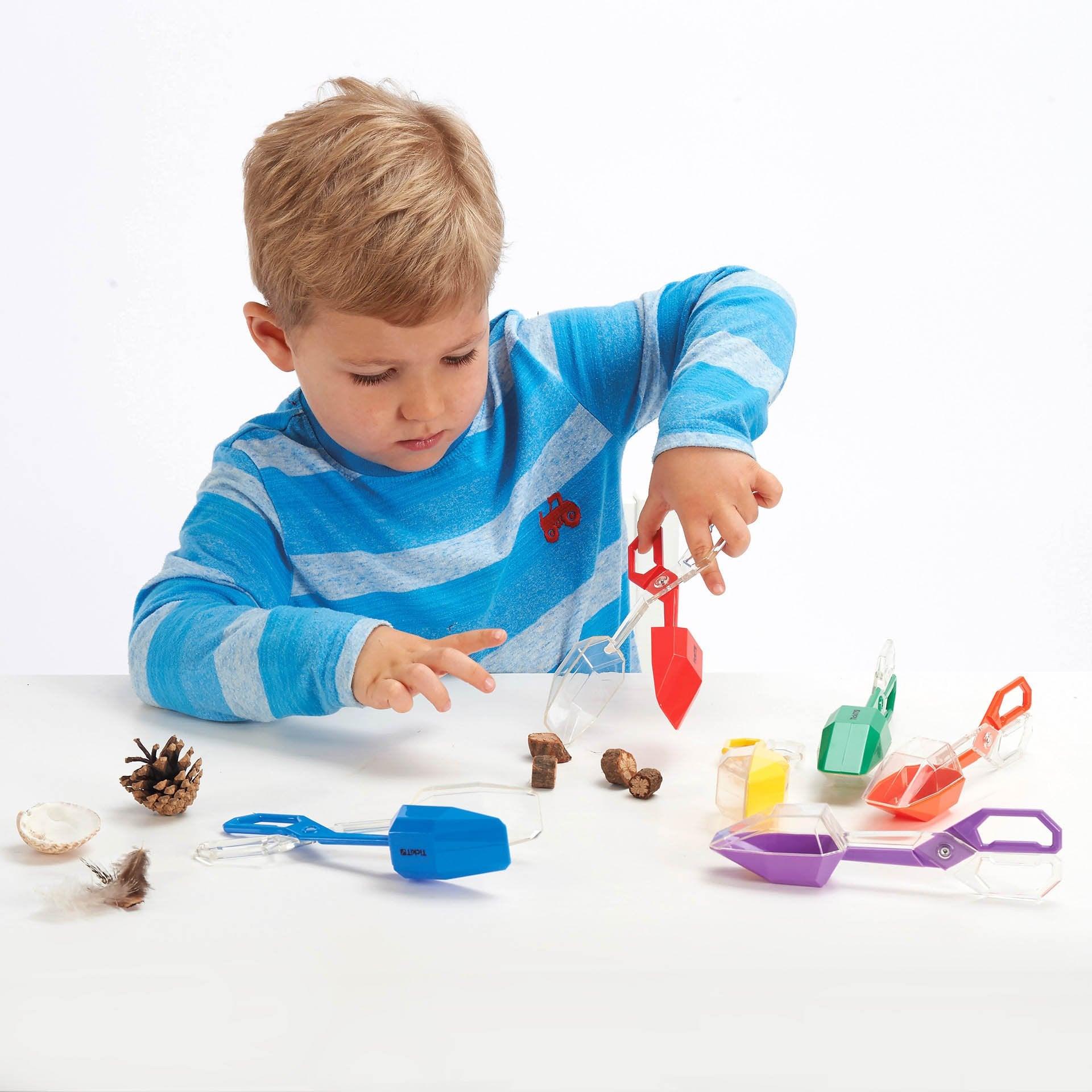Rainbow Tongs Set of 6, Get a grip on fine motor skills with this tong set containing 6 scoops! The brightly coloured Rainbow Tongs have clear tops for easy observation and scissor handles for safely capturing, holding and inspecting insects or plants. The Rainbow Tongs come in 6 colours, 1 colour each: red, blue, green, yellow, orange and purple. They are ideal for developing a number of early skills, specifically fine motor skills, hand-to-eye coordination. Holding the tongs help children practice scissor