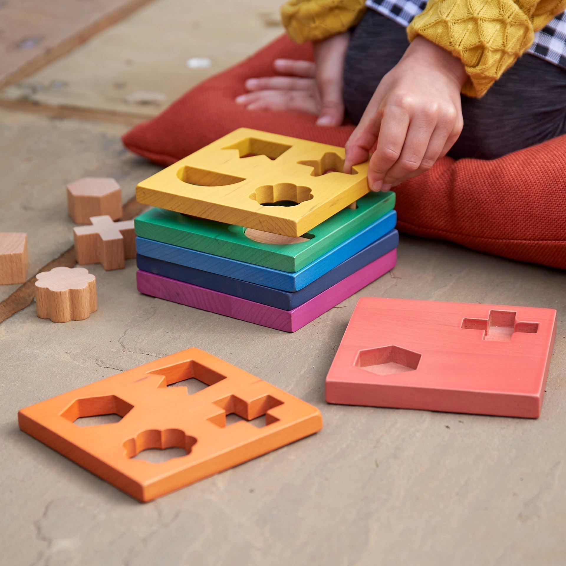 Rainbow Wooden Shape Stacker, Our TickiT® Rainbow Wooden Shape Stacker is a colourful and fun puzzle to help your child with shape recognition and problem solving skills. Made from beautiful smooth solid beechwood with a natural woodgrain finish in the 7 different colours of the rainbow. The 12 tactile shape cut outs nest inside a rounded square panel so your child can practice fitting them into their matching shaped hole or stack them to build a rainbow shape tower. The wooden panels are red, orange, yello