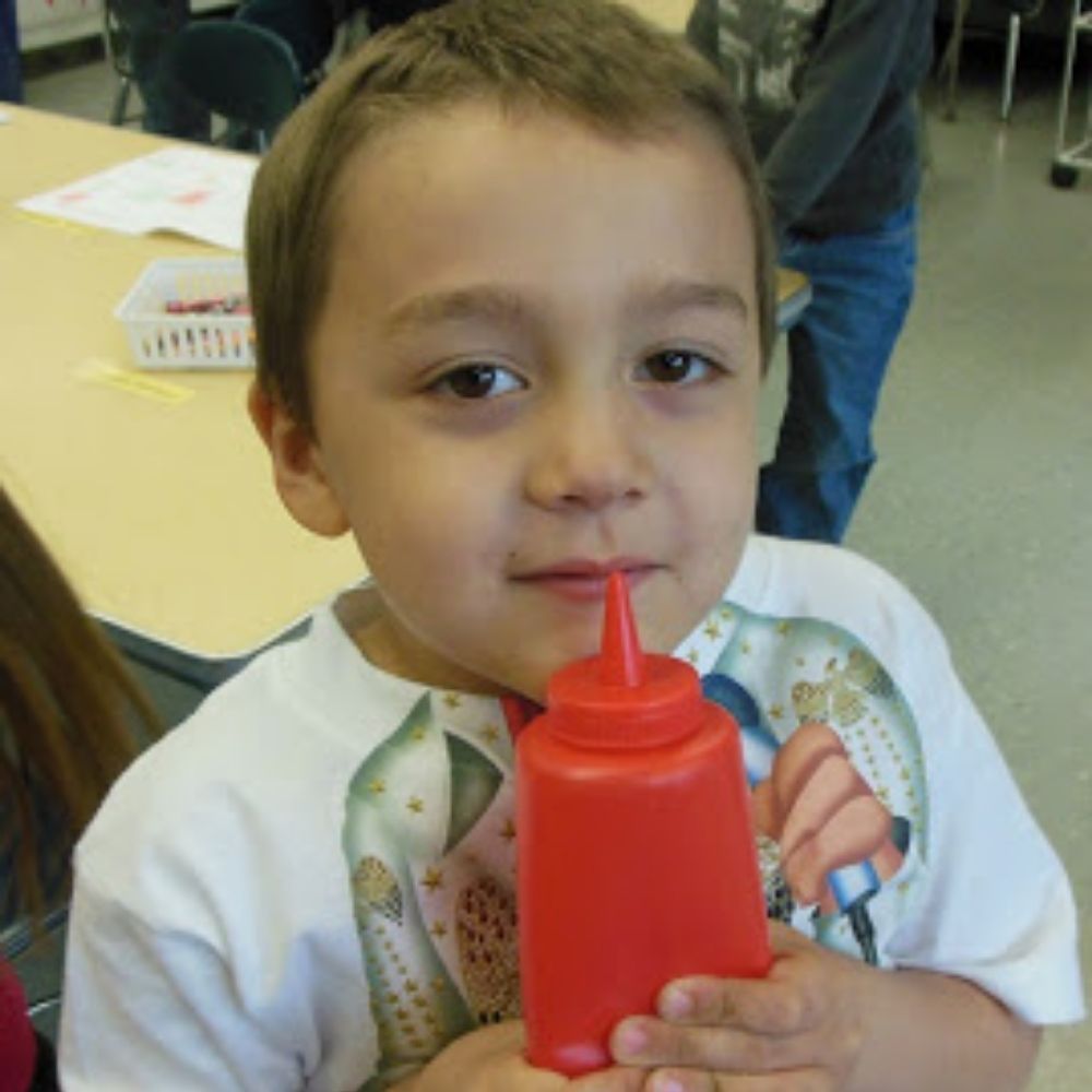 Red Sauce Bottle, The Red Sauce Bottle is a versatile and creative tool for enhancing children's sensory play and learning experiences. Here are some of its applications: Sensory Exploration: Fill the sauce bottle with different materials like sand, water, or gel beads to offer a range of tactile experiences. The child can squeeze the bottle to feel the texture and consistency of the materials inside. Guess the Smell: Fill the bottle with a variety of scents like vanilla, lemon, or lavender. Children can sq