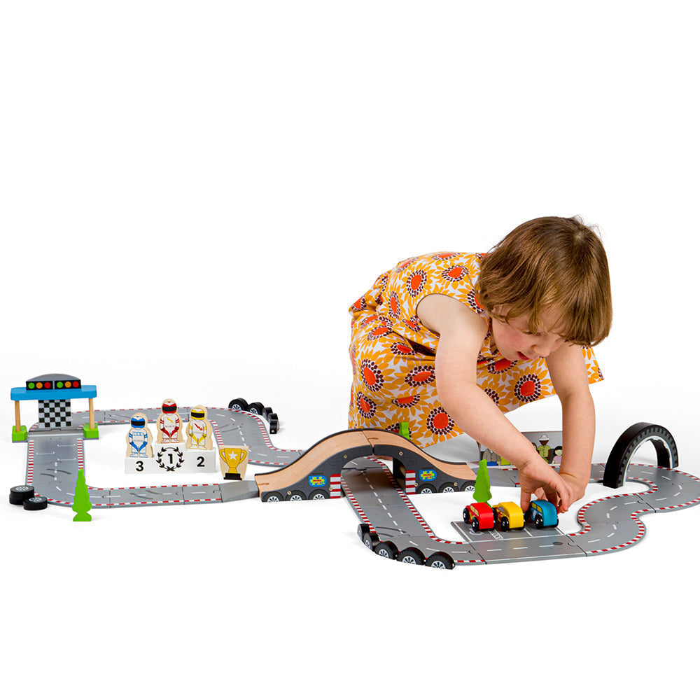Roadway Race Day, On your marks, get set, go! Zoom around corners and race to the finish line with our brand new Race Track Toy Roadway. The perfect gift for little Formula 1 fanatics. Our impressive 47-piece wooden car track is packed with three race cars, three race car drivers, a male & female mechanic, a podium, and a grand stand stadium for spectators plus plenty of accessories such as barriers, traffic lights, flags, and cones. The race track features skid marks, oil spills and a pit stop. Great for i