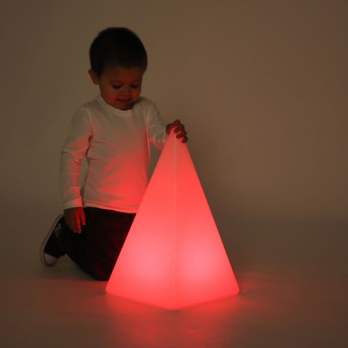 Sensory Mood Pyramid, The Sensory Mood Pyramid is a ultra-strong illuminated hollow plastic forms are aesthetically pleasing objects and can be placed around the room or used in a sensory den to provide background lighting. The Sensory Mood Pyramid provides a mood inducing light to any sensory room. Using the remote control you can choose one of 16 different colours or set to fade smoothly through the entire spectrum of shades from a cool ultra-violet to a warm red. Their appearance is mesmeric and the colo