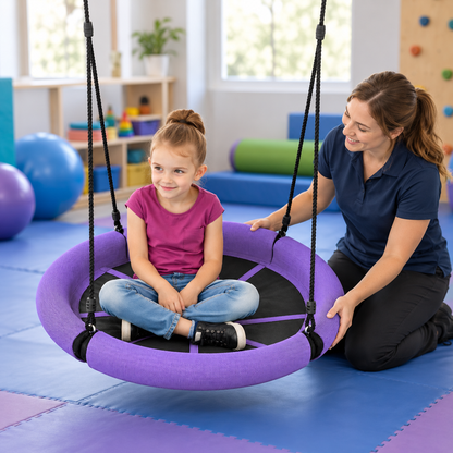 Purple Sensory Nest Swing in a sensory therapy room