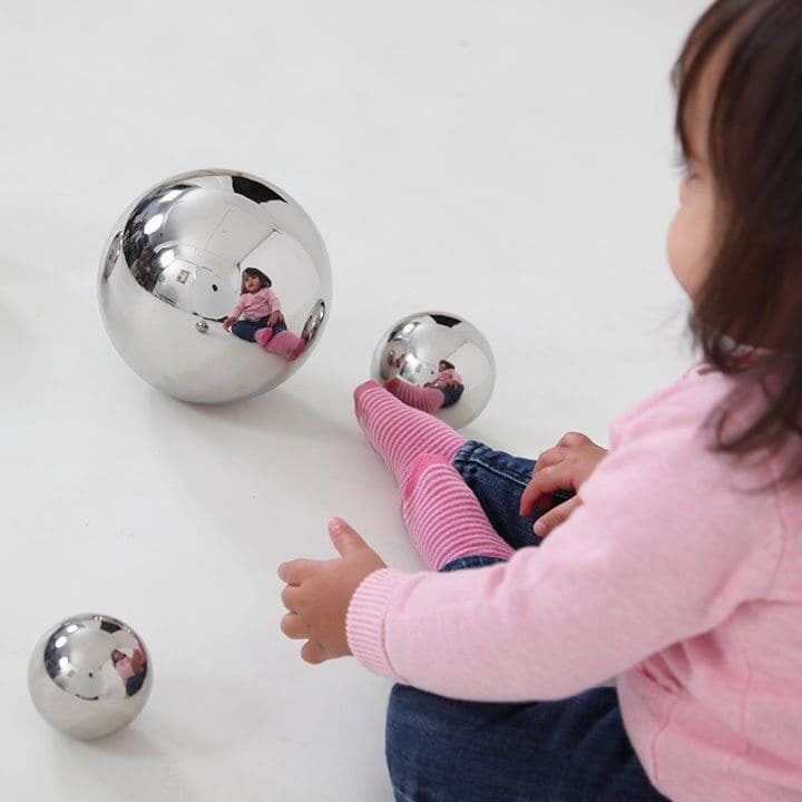 Sensory Reflective Balls Silver Pack of 4, These eye-catching Hollow Sensory Reflective Balls provides sensory exploration in a fun and engaging way. The Silver Reflective sensory Balls are hollow and very light weight, with a Metalic convex mirror-effect high reflective finish, and provides a great hand to eye coordination resource. Your child will enjoy making funny faces as they watch their stretched reflection in the surface and will find the way light reflects at different angles from the curved surfac