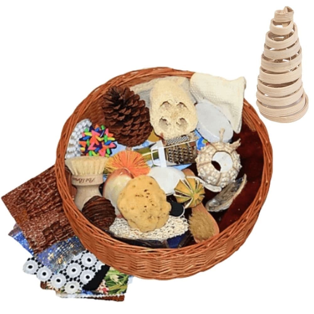 Sensory Treasure Basket, Explore, discover, and immerse yourself in the world of senses with our Sensory Treasure Basket! Crafted for children beginning their journey into understanding their environment, this basket is not just a toy but an experience that unfolds the magic of senses. Features: Diverse Textures: Dive into a range of tactile sensations. From the rugged touch of bark to the gentle caress of silk, every object offers a unique texture to explore and differentiate. Captivating Sounds: Engage yo