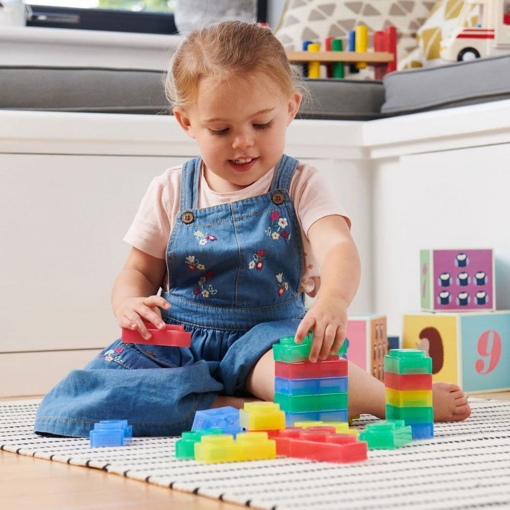 SiliShapes Soft Bricks Pk24, These perfectly sized SiliShapes Soft Bricks are made to fit a young child’s hand with ease and can be stacked, placed and arranged into patterns or sorted. The SiliShapes Soft Bricks interlock in a row or around a corner and provide young children with their first building brick set. The SiliShapes Soft Bricks are made from a special see-through silicon which is soft and flexible to the touch and safe to handle by children of any age. The SiliShapes Soft Bricks are ideal for us