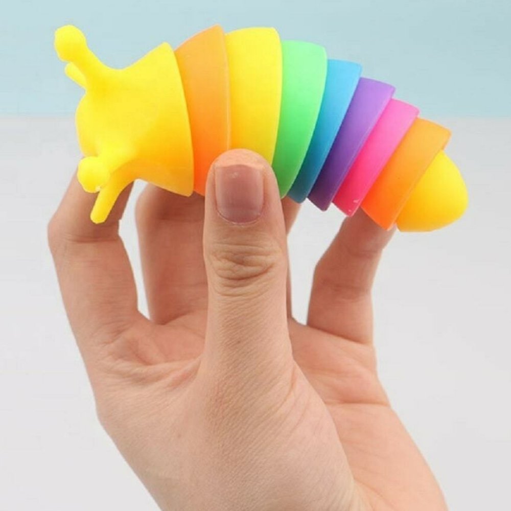 Slug Fidget Toy 10cm Rainbow, Introducing our mesmerizing Slug Fidget Toys! Measuring a perfect 10cm in size, these little creatures will surely capture your attention with their vibrant rainbow theme. Designed with ingenuity in mind, these fidget toys offer an incredibly satisfying sound as they are twisted, bent, compressed, and extended. The possibilities are endless! You'll find yourself lost in hours of sensory fun, relieving stress, anxiety, and alleviating boredom in a uniquely satisfying way.Not onl