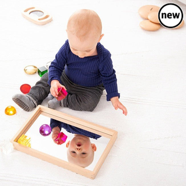 Small Wooden Mirror Tray, Our new beechwood small mirror tray is ideal for children to use independently to learn about reflection and mirror effects, to closely inspect interesting objects, for use in imaginative play and to create small world environments. The solid construction of the Small Wooden Mirror Tray provides a stable base for the 2mm acrylic mirrored base, providing a sharp clear bright reflection. Small Wooden Mirror Tray Supports the following areas of learning:• Understanding the World - obs