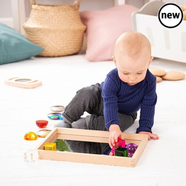 Small Wooden Mirror Tray, Our new beechwood small mirror tray is ideal for children to use independently to learn about reflection and mirror effects, to closely inspect interesting objects, for use in imaginative play and to create small world environments. The solid construction of the Small Wooden Mirror Tray provides a stable base for the 2mm acrylic mirrored base, providing a sharp clear bright reflection. Small Wooden Mirror Tray Supports the following areas of learning:• Understanding the World - obs